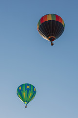 Colored balloons flying through the blue sky. Utah, US