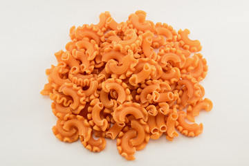 Dry colored italian pasta on white background