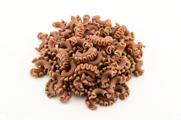 Dry colored italian pasta on white background