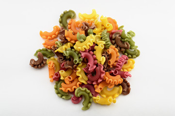 Dry italian pasta in five colours on white