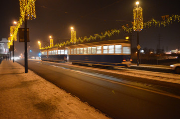 Fototapeta na wymiar Tramwaj zimową nocą w Krakowie/A tram in winter night in Cracow, Lesser Poland, Poland