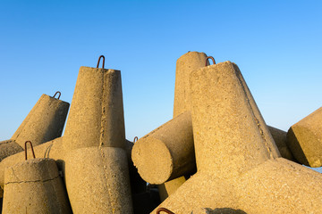 Breakwater protection under blue sky, solid concrete blocks in port of Wladyslawowo. Baltic Sea. Poland, Europe.	
