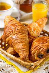 Croissants pastry for breakfast with tea and orange juice
