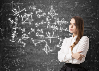 Woman with a braid and formulas on blackboard