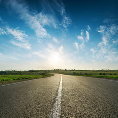 sunset in blue sky over asphalt road