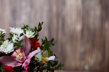 Bouquet of exquisite flowers on wood