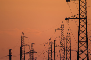 Silhouette of the electricity transmission pylon at sunset