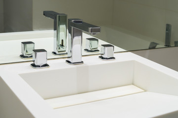 Washbasin and faucets in the bathroom mirror
