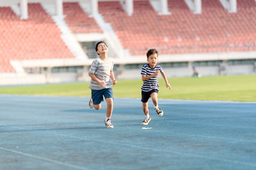Boy running on the blue track