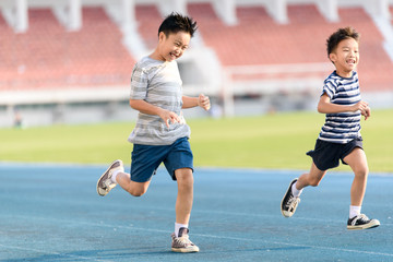 Boy running on the blue track