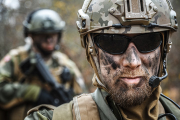 Norwegian Armed Forces Special Command FSK male and female soldiers closeup portrait. Radio and...