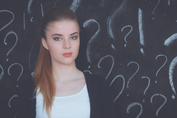 Young girl with question mark on a gray background