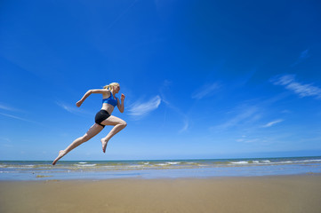 Women Jogging along sandy beach.