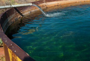 Pipe Filling Large Tank with Water, Sedona, Arizona, USA, horizontal