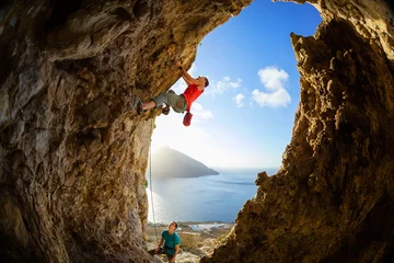 Rolgordijnen Rock climbers in cave © Andrey Bandurenko