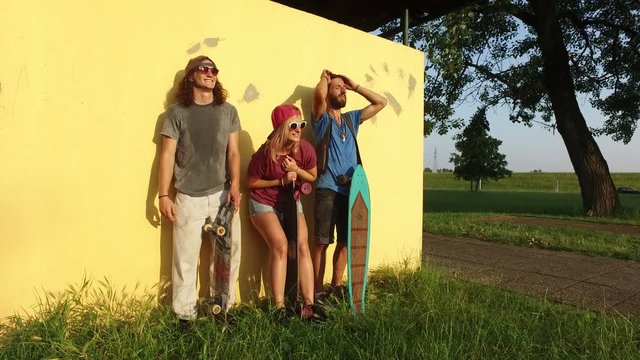 Happy friends having fun chilling and joking after skateboarding