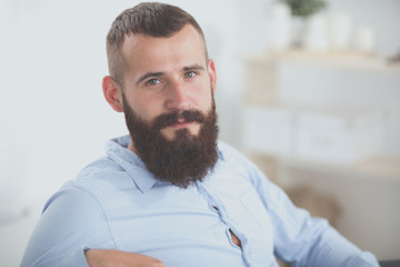 Young businessman sitting on chair in office