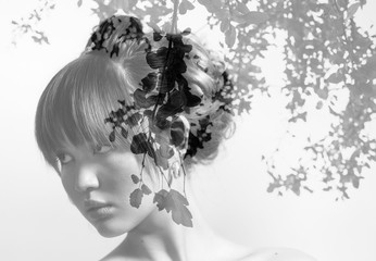 Monochrome double exposure of beautiful bride and leaves