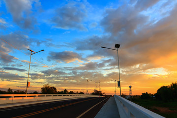 Sunrise. Road bridge across the river.