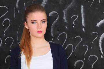 Young girl with question mark on a gray background