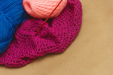 Hanks of bright yarn for knitting on a bright background with copyspace