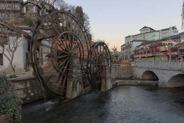 Lijiang, China - March 17, 2017: Bridge and Water wheels at the entrance on Lijiang Old Town in Yunnan