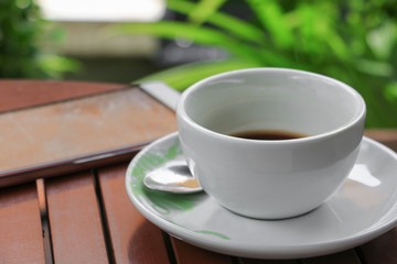 coffee cup on the wood floor background