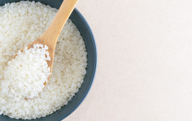 Rice in wooden spoon on bowl