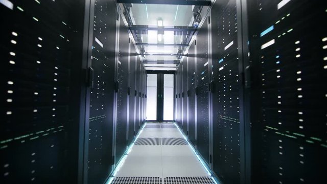 Camera Moving Backwards in Working Data Center Shot. Rows of Rack Servers, Glass Ceiling and LED Lights are Seen. Shot on RED EPIC-W 8K Helium Cinema Camera.