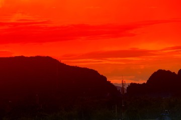 sunset in sky and cloud, beautiful colorful twilight time with mountain silhouette