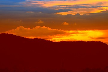 sunset in sky and cloud, beautiful colorful twilight time with mountain silhouette