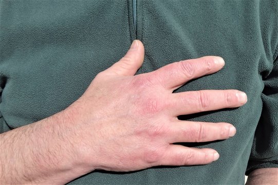A man's hand on his chest
