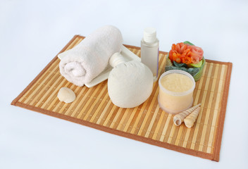 Spa herbal compressing ball with towels and Salt Scrub, Spa concept on bamboo weave mat against white background