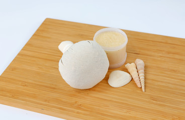 Spa herbal compressing ball and Salt Scrub, Spa concept on bamboo board against white background
