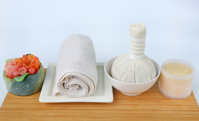 Spa herbal compressing ball with towels and Salt Scrub, Spa concept on bamboo board against white background