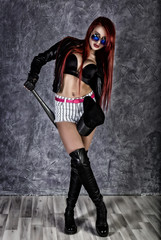 Hipster haughty girl with big tits in sunglasses and black jacket standing, holding baseball bat. retro concept