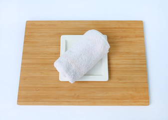 Spa concept, Towels on bamboo board against white background