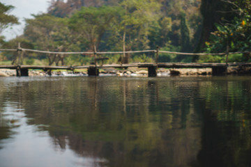 Fototapeta na wymiar bamboo bridge over the river