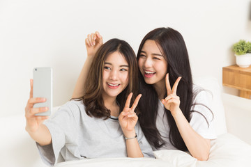 Young asian ladies take selfie