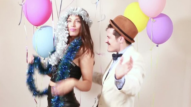 Funny crazy couple having fun in party photo booth