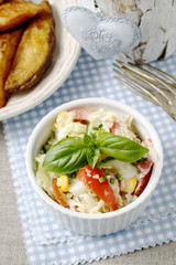 Vegetable salad decorated with basil leaf