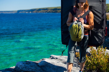 Beautiful woman boudering rock climbing on the shore