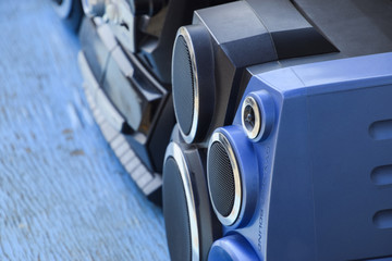 Cassette tape recorder with radio on a blue wooden table. Vintag