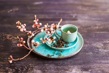 Green tea and peach blossom as a spring concept