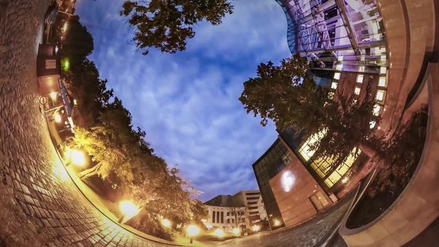 Rabbit Hole Planet 360 Degree Lit Cobblestone Square Near Luxurious New Building in Evening Lively Place With Tourists Romantic Cityscape of Old City