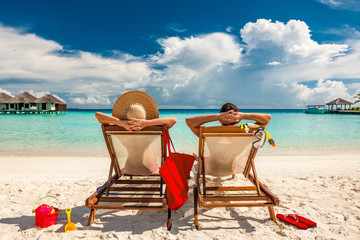 Couple in loungers on beach at Maldives - 141937511