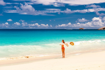 Woman with sarong on beach at Seychelles