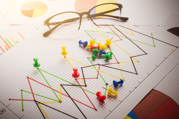 Close up of pin on graph data