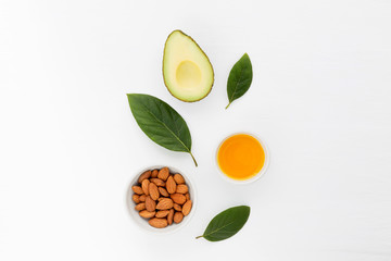 Almond and avocado oil in bowl. Skin care and hair loss ingredients.