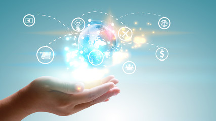 Hand holding world with social media icons.